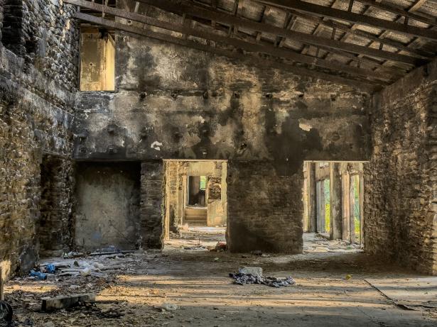 Interior,Of,An,Abandoned,,Burned,House,With,Charred,Stone,Walls,
