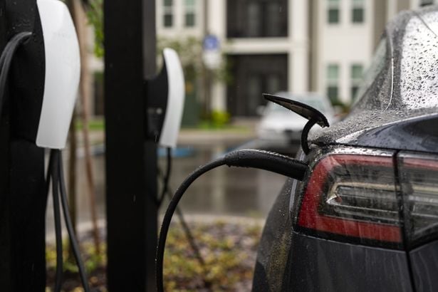 Electric,Car,Charger,With,Cable.,Electric,Car,At,A,Charging | Shutterstock