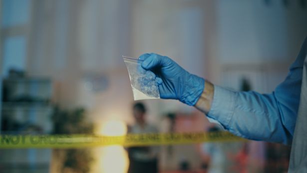 A,Detective,Is,Examining,An,Illegal,Substance,Found,At,The | Shutterstock