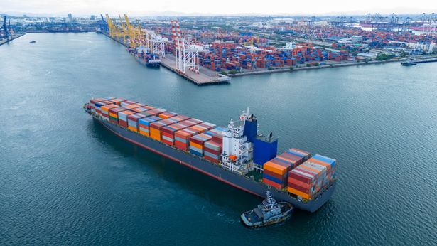 Large,Cargo,Container,Ship,Being,Assisted,By,A,Tugboat,As | Shutterstock